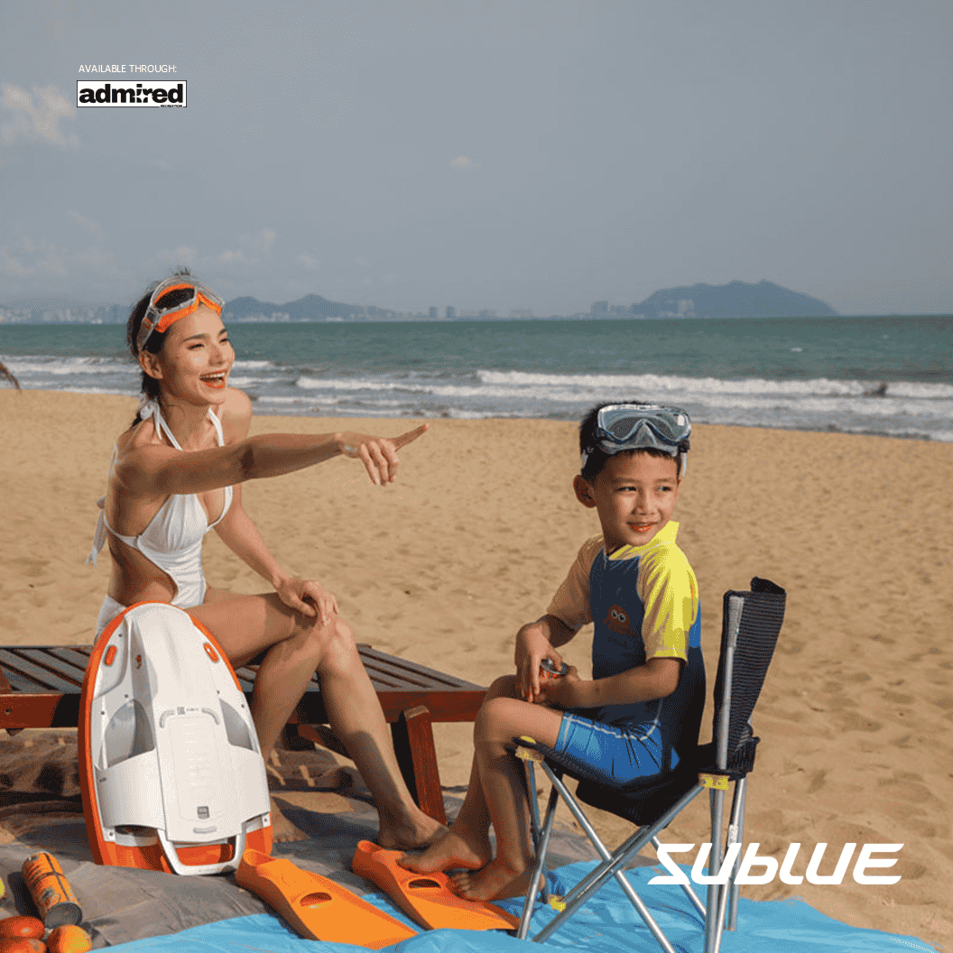 Woman and child on the beach with SUBLUE Swii kickboard, enjoying a sunny day.