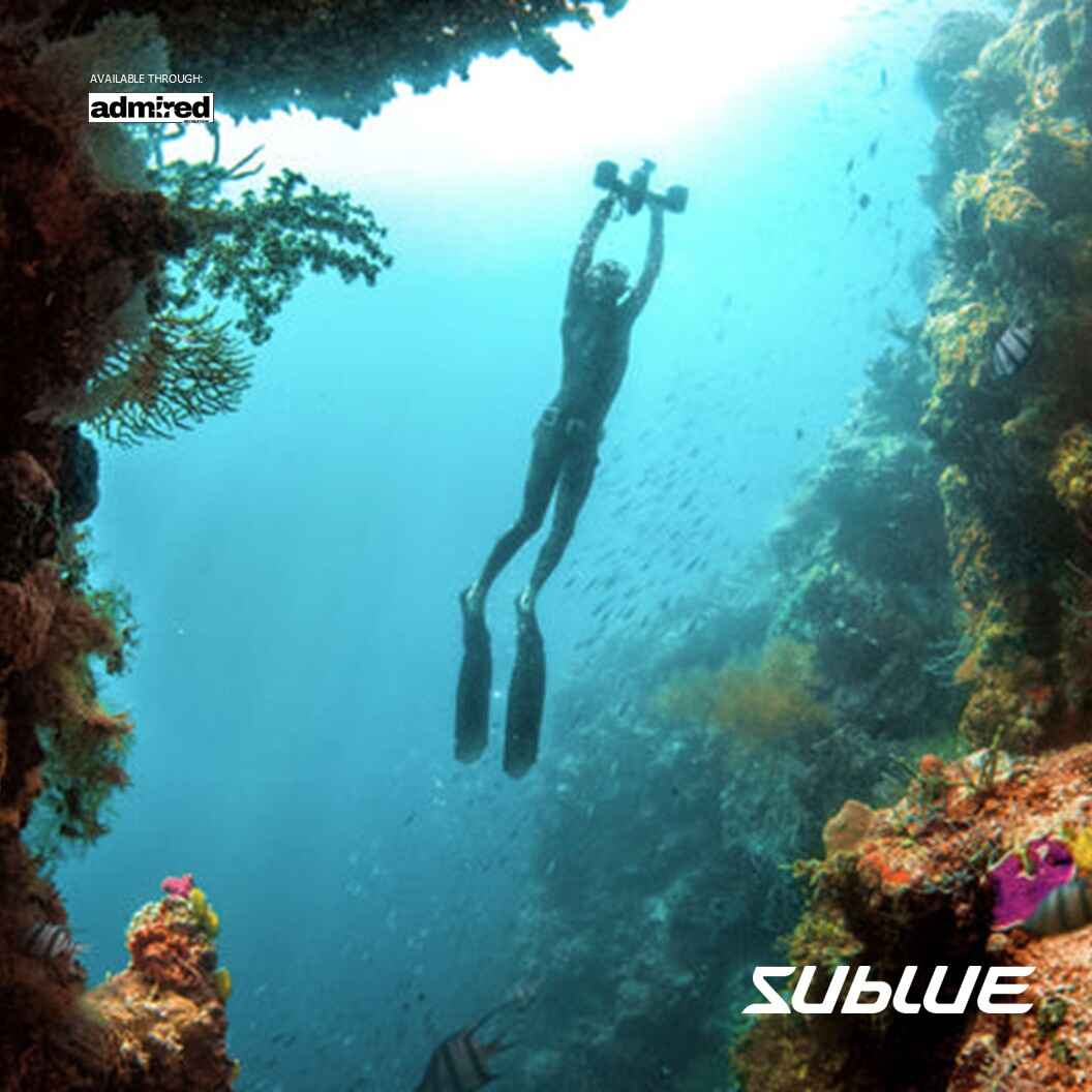 Child gliding underwater with SUBLUE MixPro scooter near colorful coral reef.