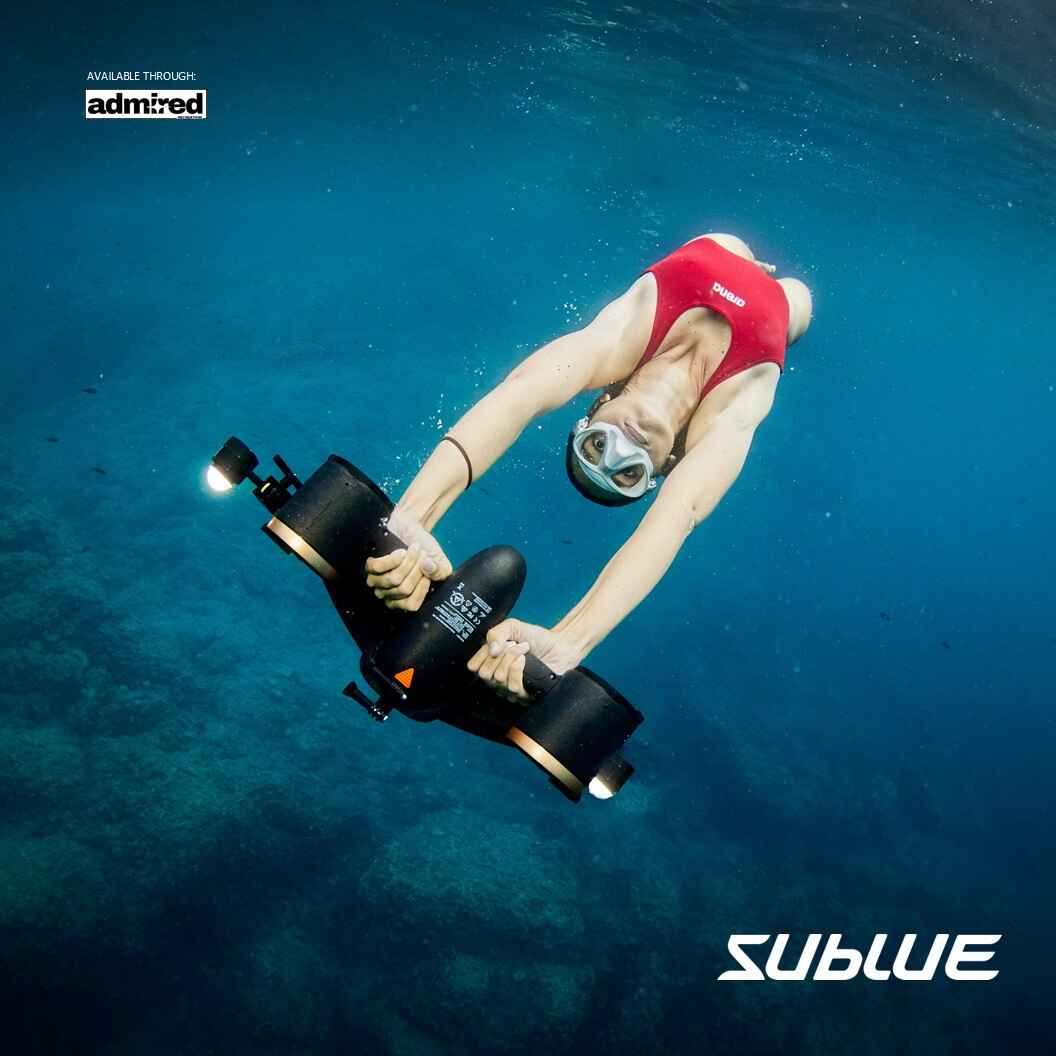 Swimmer using SUBLUE MixPro underwater scooter in clear blue water.