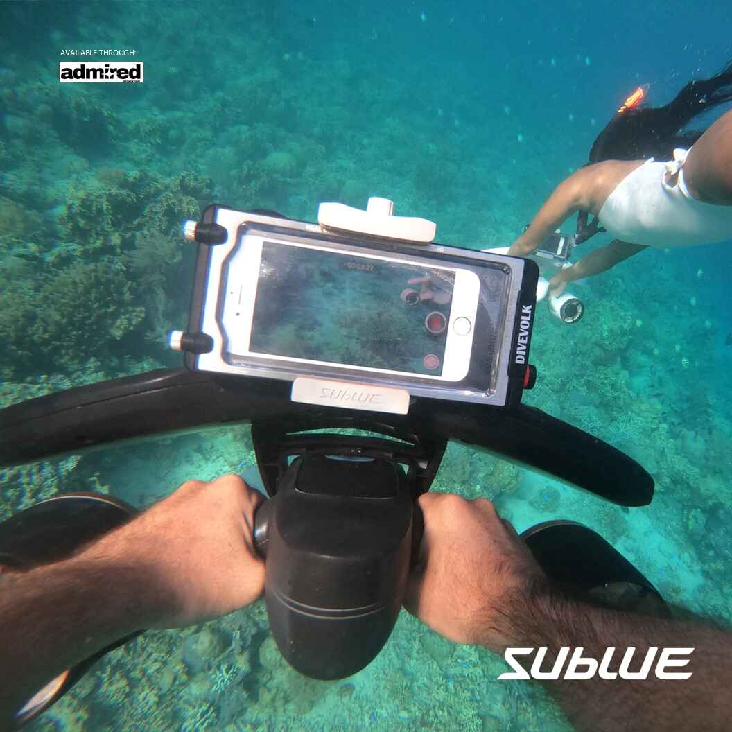 Diver using SUBLUE MixPro underwater scooter with smartphone mount for capturing underwater moments.