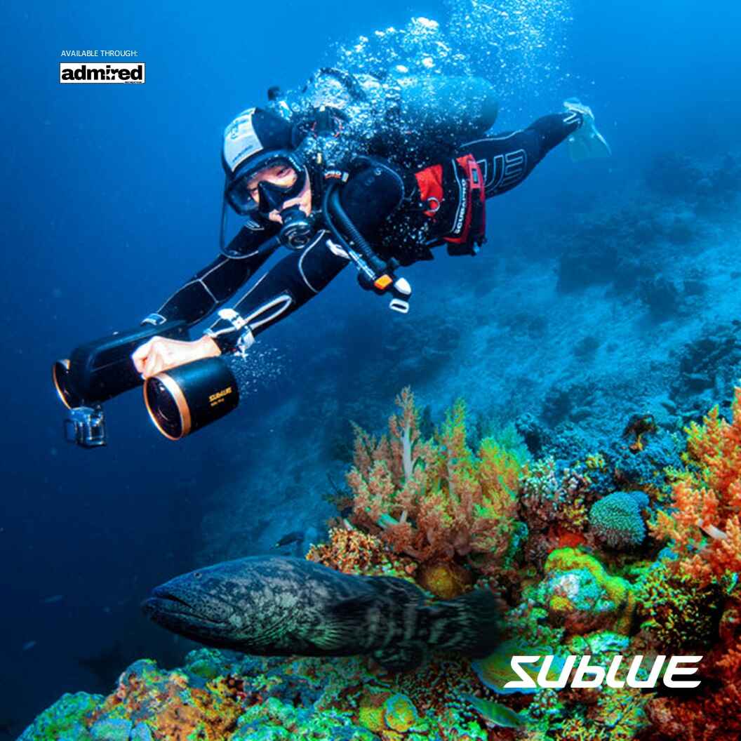 Diver using SUBLUE MixPro underwater scooter near colorful coral reef