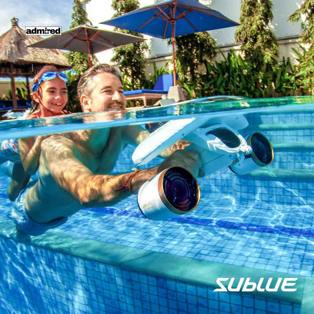 Adult and child using SUBLUE MixPro underwater scooter in a pool.