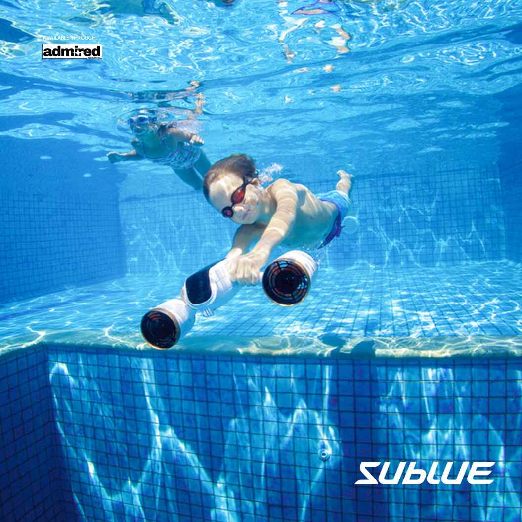 Child gliding underwater with SUBLUE MixPro scooter in a bright pool.