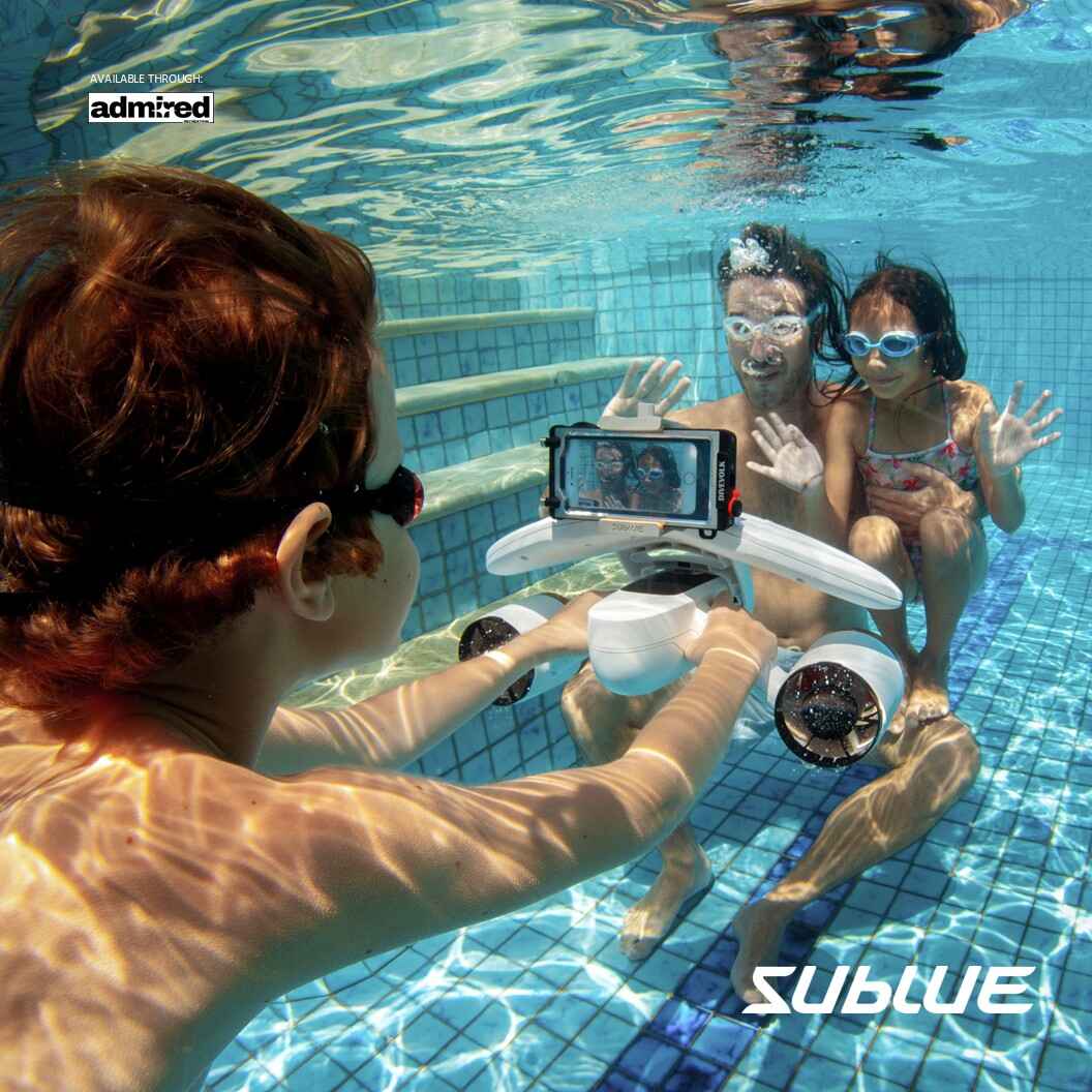 Child gliding underwater with SUBLUE MixPro scooter in a bright pool.