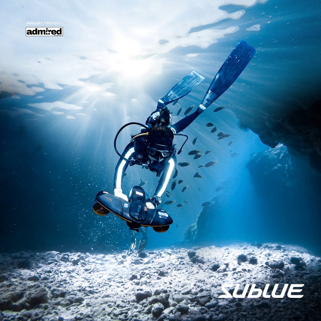 Diver using SUBLUE Navbow+ scooter exploring underwater landscape with sunlight