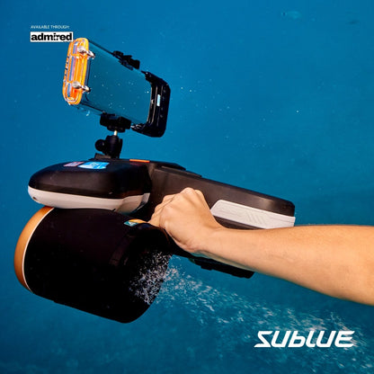 Diver using SUBLUE Navbow+ underwater scooter with camera mount in clear blue water.